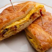Breakfast croissant · egg, bacon, and cheddar cheese on a jumbo butter croissant.