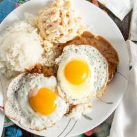 Loco Moco · Savory homemade hamburger patties over rice covered with brown gravy and topped with eggs.