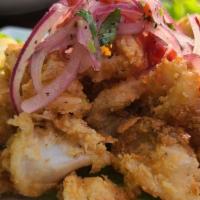 Chicharones Calamar / Fried calamari · Breaded calamari, seasoned with Peruvian species. Served with yuca and red onion salad. Trus...