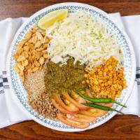 8. Tea Leaf Salad · Burmese tea leaves, cabbage, tomatoes, fried garlic, fried yellow beans, sunflower seeds, pe...