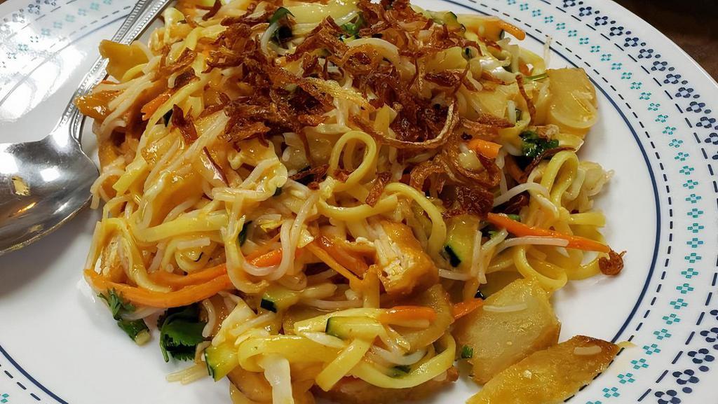 11. Rainbow Salad · Cabbage, rice noodle, egg noodle, cucumber, carrot, cilantro, fried potato, fried tofu, red onion, and fried onion on top.