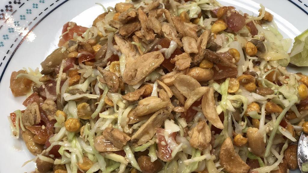 9. Ginger Salad · Pickled ginger, cabbage, lettuce, tomato, fried yellow beans, sunflower seeds, peanuts, and sesame seeds all mixed with tasty bean powder serve with one slice lime.