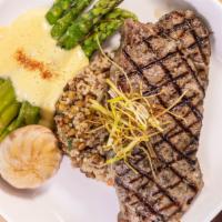 New York Steak · Served with sautéed asparagus & roasted  Yukon potatoes. Topped with herbed  compound  butter