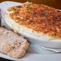 The Chieftain Shepherd’s Pie · Baked with ground lamb, peas, carrots and onions with a mashed potato crust.  Served with br...