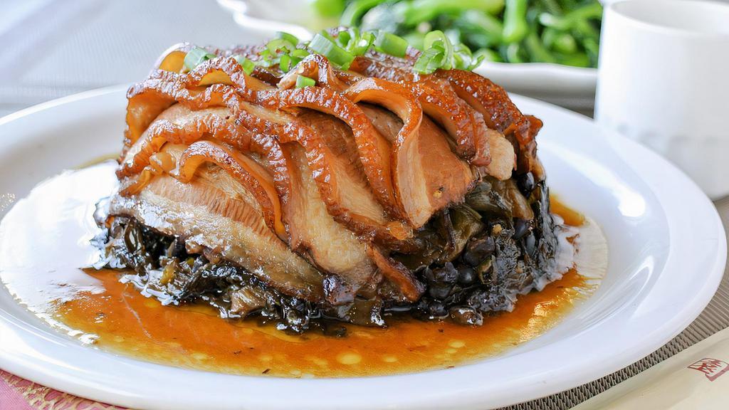 Braised Pork Over Salted Vegetables 梅菜扣肉 · Braised pork belly over a bed of salted Chinese mustard greens, topped with scallions.