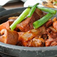 House Special Braised Lamb 老家紅燒羊肉 · Lamb with bone, braised in a soy sauce based dark sauce with carrots and onions.