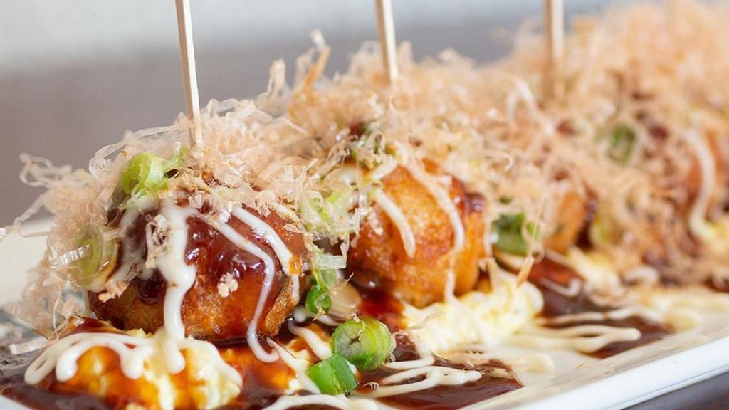 Takoyaki - Octopus Balls · Octopus balls. Battered octopus over egg tartar topped with mayonnaise, okonomiyaki sauce, fresh cut green onion and smoked bonito flakes.
