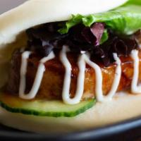 JINYA Bun · Steamed bun stuffed with slow braised pork chashu, cucumber and baby mixed greens served wit...