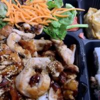 Chicken Bento · 800 cal. Served with steamed rice, four pieces California roll, three pieces dumplings and m...
