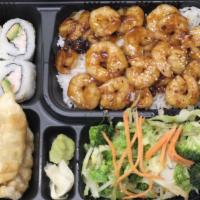 Shrimp Bento · 730 cal. Served with steamed rice, four pieces California roll, three pieces dumplings and m...