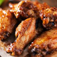The Kansas Wings · Crispy oven-baked chicken wings topped with bbq flavored sauce.
