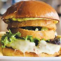Pompéia Burger · 6oz grass fed burger with gouda cheese, cilantro mayonnaise, spring mix and onion rings on a...