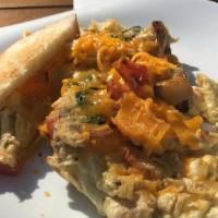 Veggie Scramble · Vegetarian. Three eggs scrambled with red potatoes, red peppers, tomatoes, red onions, spina...