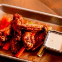 6pc Wings · 6 double fried pastured raised wings served with carrots, celery and your choice of ranch or...