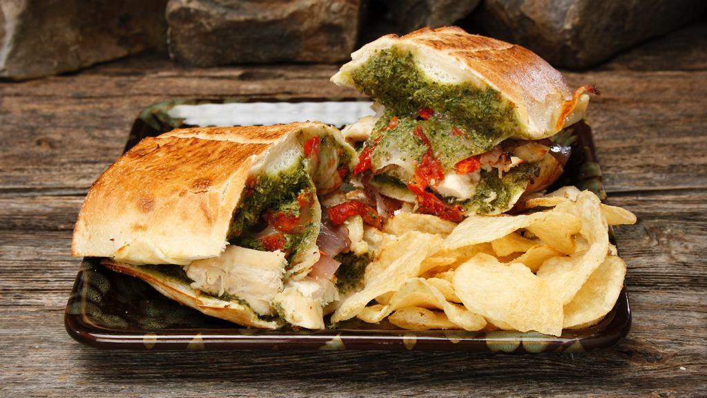 Chicken Pesto · Calories 510. Heated. Tender chicken with pesto, caramelized onions, sun-dried tomatoes and provolone.