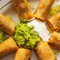 Taquitos · Corn tortillas filled with chicken or shredded beef, side of sour cream and guacamole.