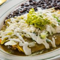 Enchiladas Chilangas · Two green enchiladas with chicken, topped with lettuce, queso fresco, sour cream, guacamole,...