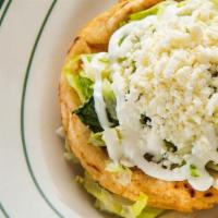 Handmade Sope · Masa patties topped with beans, lettuce, cheese, sour cream, and choice of meat.