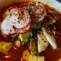 Pozole · A hearty stew made with pork, corn hominy, red chiles and all the fixings.