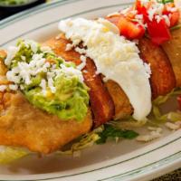 Chimichanga Loca · Same as a grande chimichanga but wrapped with bacon and topped with queso fresco, sour cream...