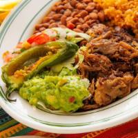Carnitas · Traditional pork carnitas served with guacamole, pico de gallo, rice, whole beans, a roasted...