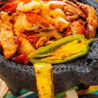 Molcajete · Grilled chicken, steak, prawns, nopales, bell peppers, onions, and tomatoes. Cooked with our...