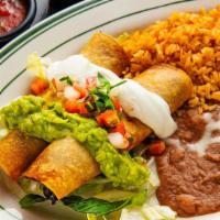 9. Flautas (2) · Two flautas  top with sour cream and guacamole.  Served with rice and re fried beans.