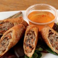 Momma Tran’s Crispy Egg Rolls · Ground pork, woodear mushrooms, glass noodles, shredded carrots, and onions served with nuoc...