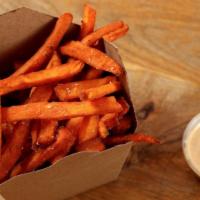 Sweet Potato Fries · Basket of sweet potato fries served with red curry mayo.