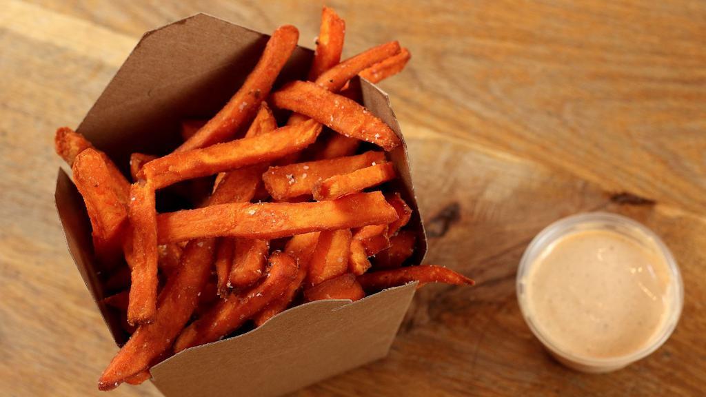 Sweet Potato Fries · Basket of sweet potato fries served with red curry mayo.