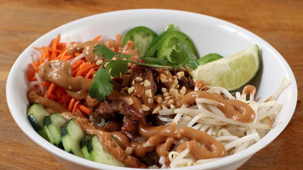 Saigon Peanut Rice Bowl · Papaya, pickled carrots and daikon, jalapenos, bean sprouts, and spicy cucumbers, topped with roasted peanuts and peanut sauce over garlic or brown rice and your choice of grilled pork or chicken.