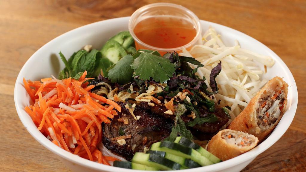 Bun Noodle Bowl with Tofu · Grilled organic tofu, vermicelli rice noodle, lettuce, pickled carrots and daikon, spicy cucumbers, Vietnamese herbs, cilantro, roasted peanuts, and crispy shallots served with a vegan nuoc cham dipping sauce. Gluten free.
