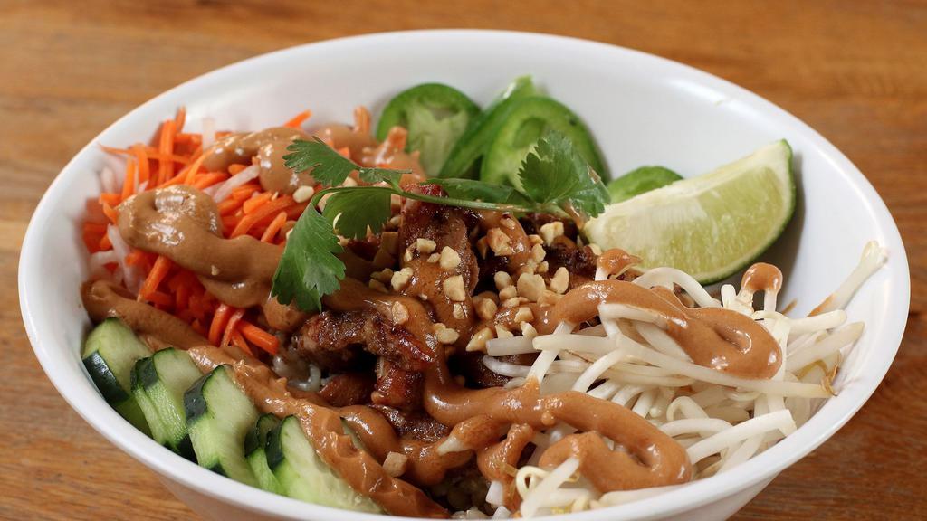 Saigon Peanut Rice Bowl with Tofu · Grilled organic tofu, papaya, pickled carrots and daikon, jalapenos, bean sprouts, and spicy cucumbers, topped with roasted peanuts and peanut sauce over brown rice.