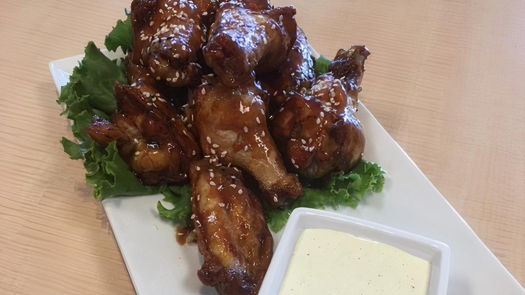 Chicken Wings · Eight chicken wings tossed in your choice of buffalo, lemon pepper, teriyaki, chipotle, or fire with ranch sauce