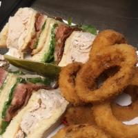Turkey Club · Oven-roasted turkey breast, lettuce, tomato and bacon pilled high on three slices of butter ...