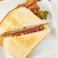 Classic BLT · Crispy thick-cut bacon, green leaf lettuce, tomato, and mayonnaise on sourdough bread.
