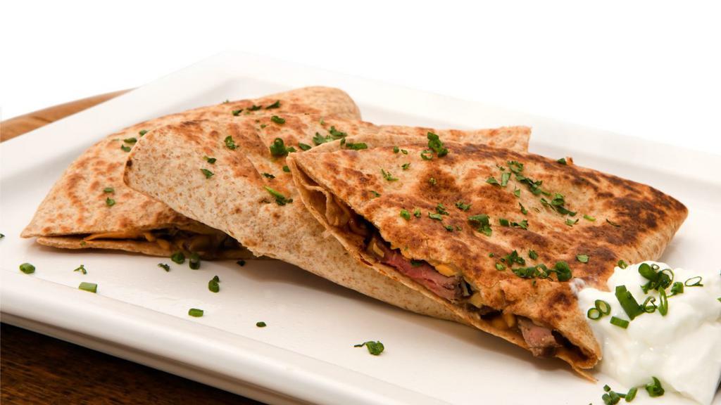 Steak Quesadilla · Artfully grilled flour tortilla filled with mouth watering steak and Jack and Cheddar cheeses. Served with tasty salsa, fresh guacamole and delicious sour cream.