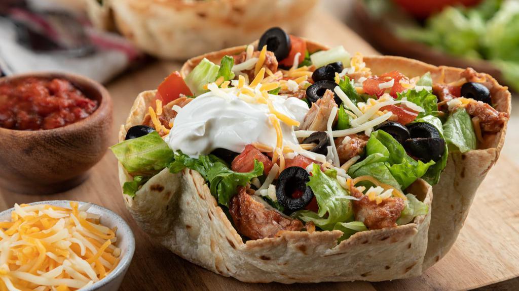 Chicken Taco Salad · Fresh chicken with a bed of romaine, rice, beans, fresh salsa, guacamole, cheeses and sour cream. Served with a crisp tortilla shell.