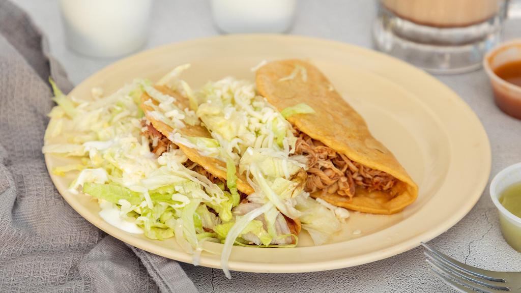 Crispy Taco · Crispy corn tortilla with chicken or beef, lettuce, cheese and & sour cream.