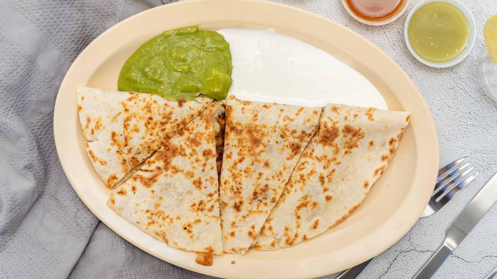 Super Flour Quesadilla · Cheese and meat served with guacamole and sour cream.