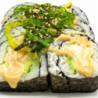 Swamp Thing Roll · Avocado and cucumber topped with seaweed salad, sesame seeds, & sesame sauce.