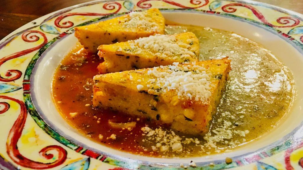 Baja Style Polenta · Grilled with corn, green chilies, smoked mozzarella cheese, served with mild red and green sauces.