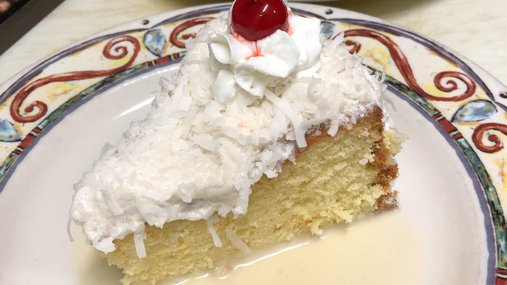 Tres Leches Cake · Covered in coconut, served with vanilla whipped cream and maraschino cherry.