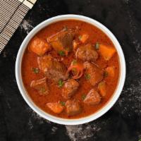 Lamb Vindaloo · Boneless lamb cooked in a spicy pungent curry with potatoes.