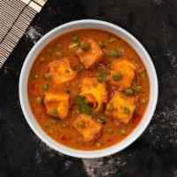 Matar Paneer · Green peas cooked with cheese in a creamy tomato sauce.
