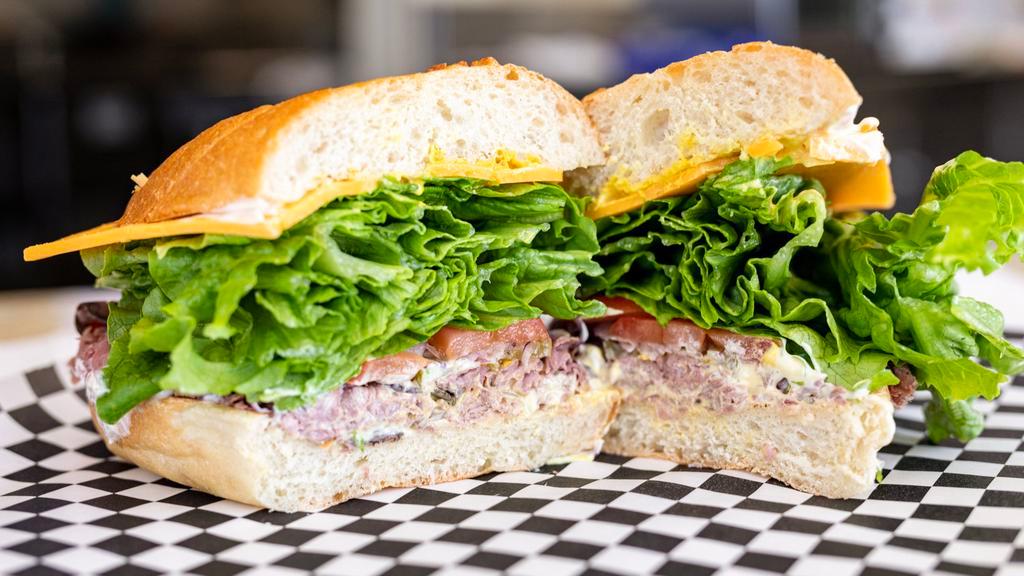 9. Leo · Roast beef, cheddar cheese, lettuce, pickles, onions, tomatoes, mayonnaise and mustard.