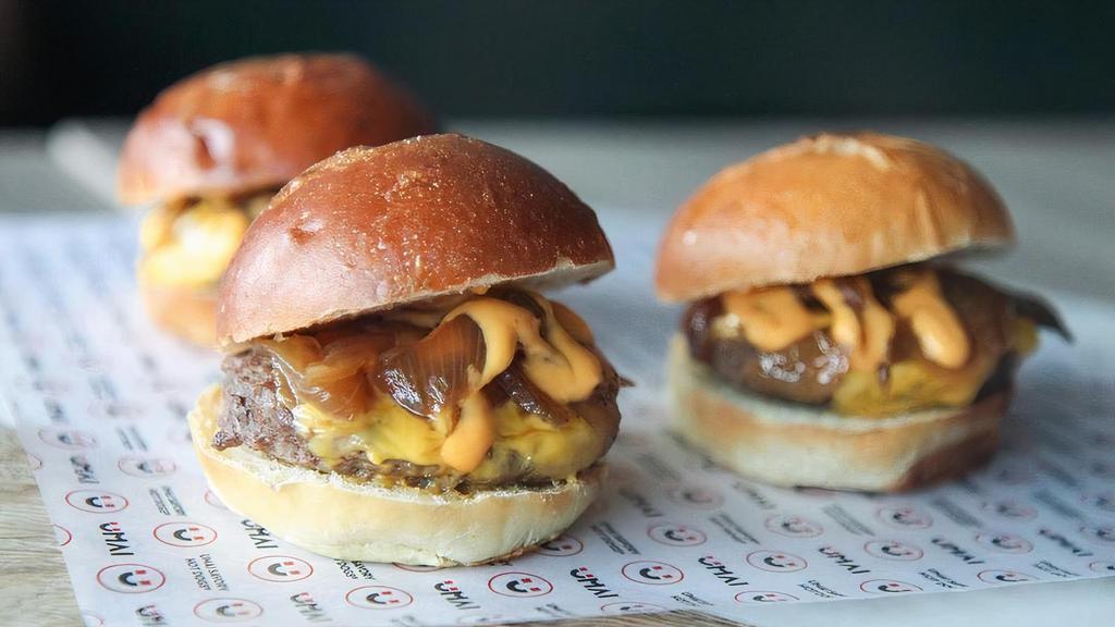 Umai Sliders · Three beef sliders, topped with American cheese, caramelized onions, Umai teriyaki, and Dynamite sauce on three brioche buns.