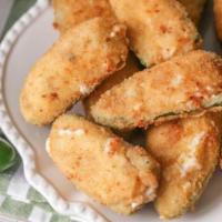 Jalapeño Poppers · Crusted cream cheese filled jalapeños with choice of dipping sauce.