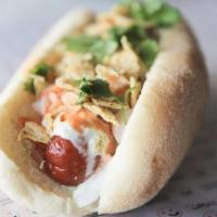 Mucho Magnificent · Spicy level two. Hot link sausage topped with diced onions, cilantro lime sauce, creamy haba...