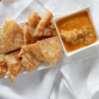 Platha & Coconut Chicken Curry Dip · Handmade multi-layered bread served with coconut chicken curry sauce for dipping.